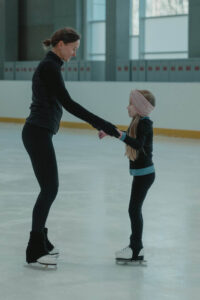 Dame en kind schaatsen samen 1
