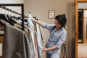 Een vrouw staat voor haar capsule wardrobe